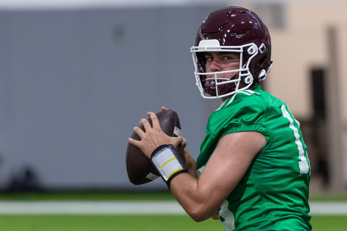 Texas A&amp;M QB Conner Weigman (15) looks to make a throw during the first day of fall football practice at the McFerrin Athletic Center in College Station Texas, on July 31, 2024. (Hannah Harrison/The Battalion)