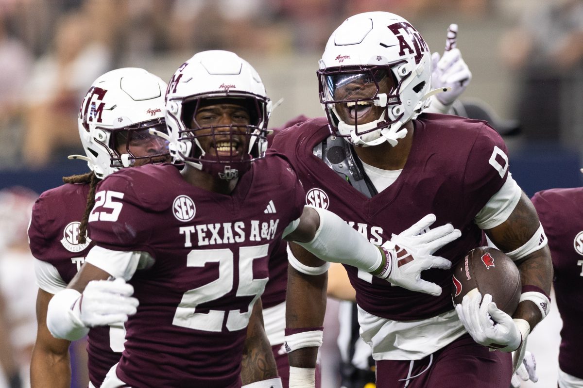 Texas A&amp;M Aggies linebacker Scooby Williams (0) and defensive back Dalton Brooks (25) react after a recovered fumble during Texas A&amp;M’s game against Arkansas at the Southwest Classic at AT&amp;T Stadium in Arlington, Texas on Saturday, Sept. 28, 2024. (Chris Swann/The Battalion)