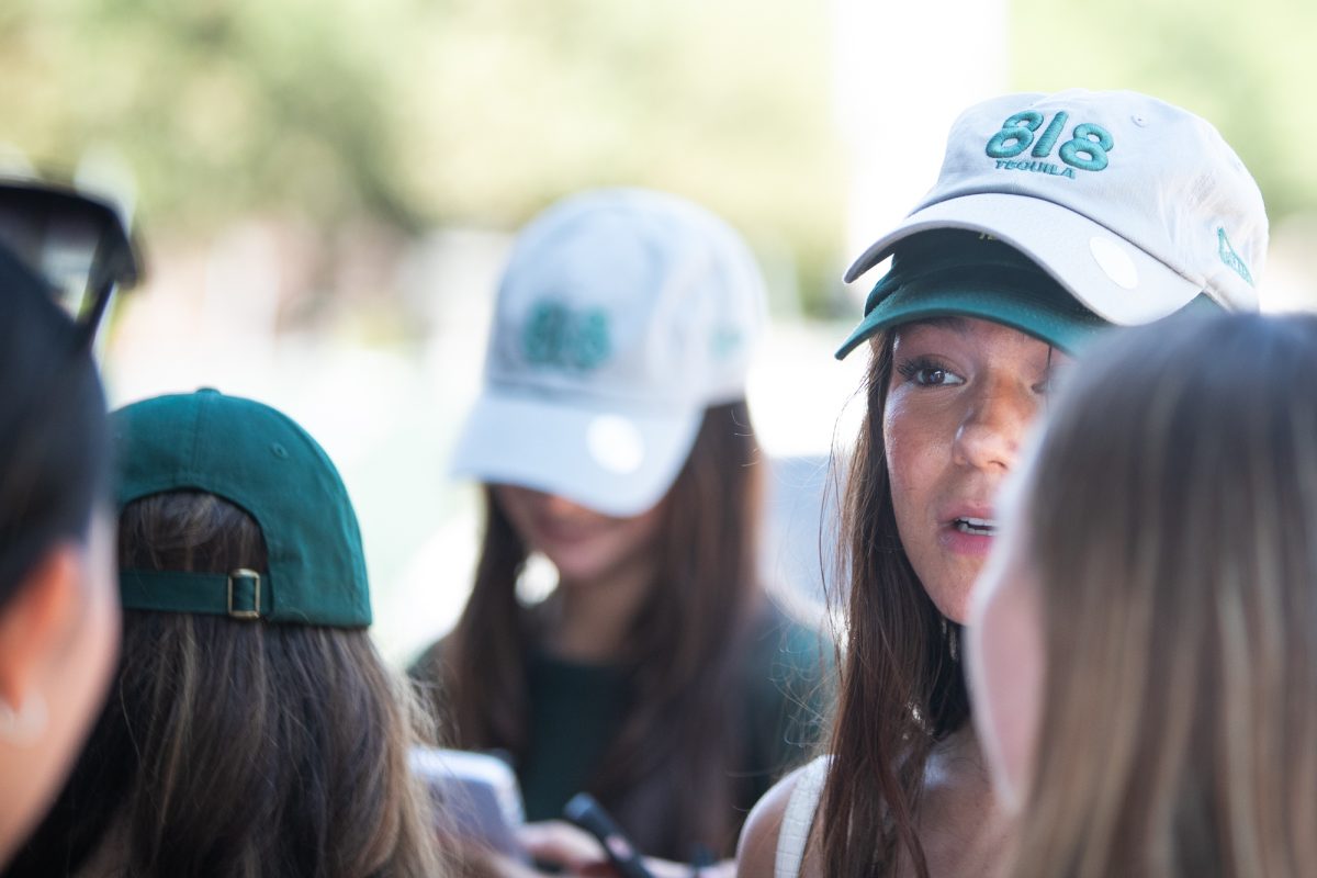 A&amp;M students grab branded hats during Kendall Jenner's 818 Tequila visit to Shiner Park on Monday, Sept. 16, 2024. (Adriano Espinosa/The Battalion)