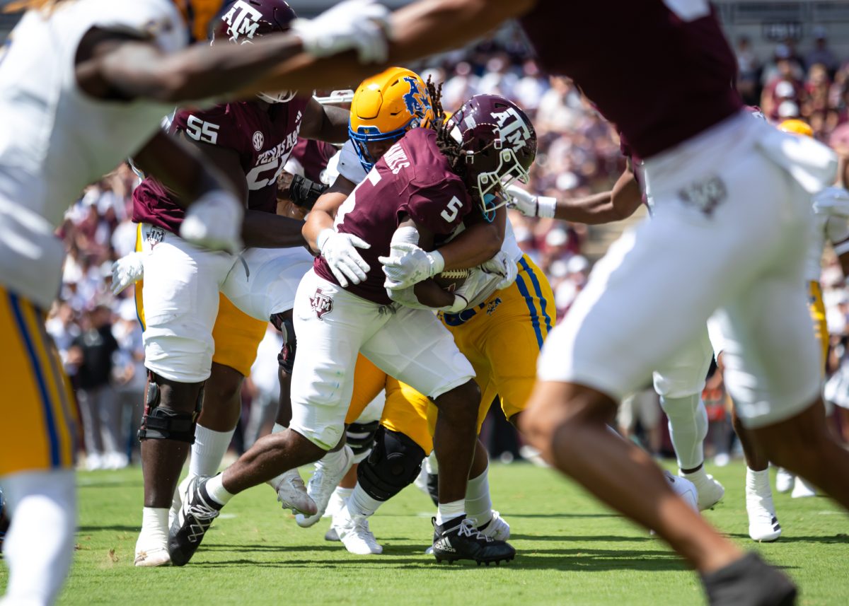 Texas A&amp;M Aggies running back Amari Daniels (5) takes a tackle during Texas A&amp;M's game against McNeese State at Kyle Field on Saturday, Sept. 7, 2024. (Adriano Espinosa/The Battalion)