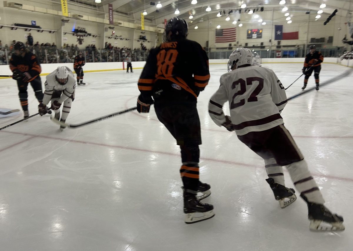 Senior forward Marshall Rushing fights off defenders during the A&M ice hockey game against Oklahoma State on Friday, Sept. 13, 2024, at Spirit Ice Arena.