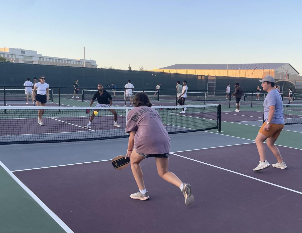 Agricultural economics senior Gunner Clapper waits as general studies freshman Greta Klein runs for the attack against kinesiology senior Ananya Luthria and industrial engineering senior Devadath Nair opening play of the Doubles Competitive Pickleball League on Sept. 9, 2024 at Omar Smith Instructional Tennis Center.