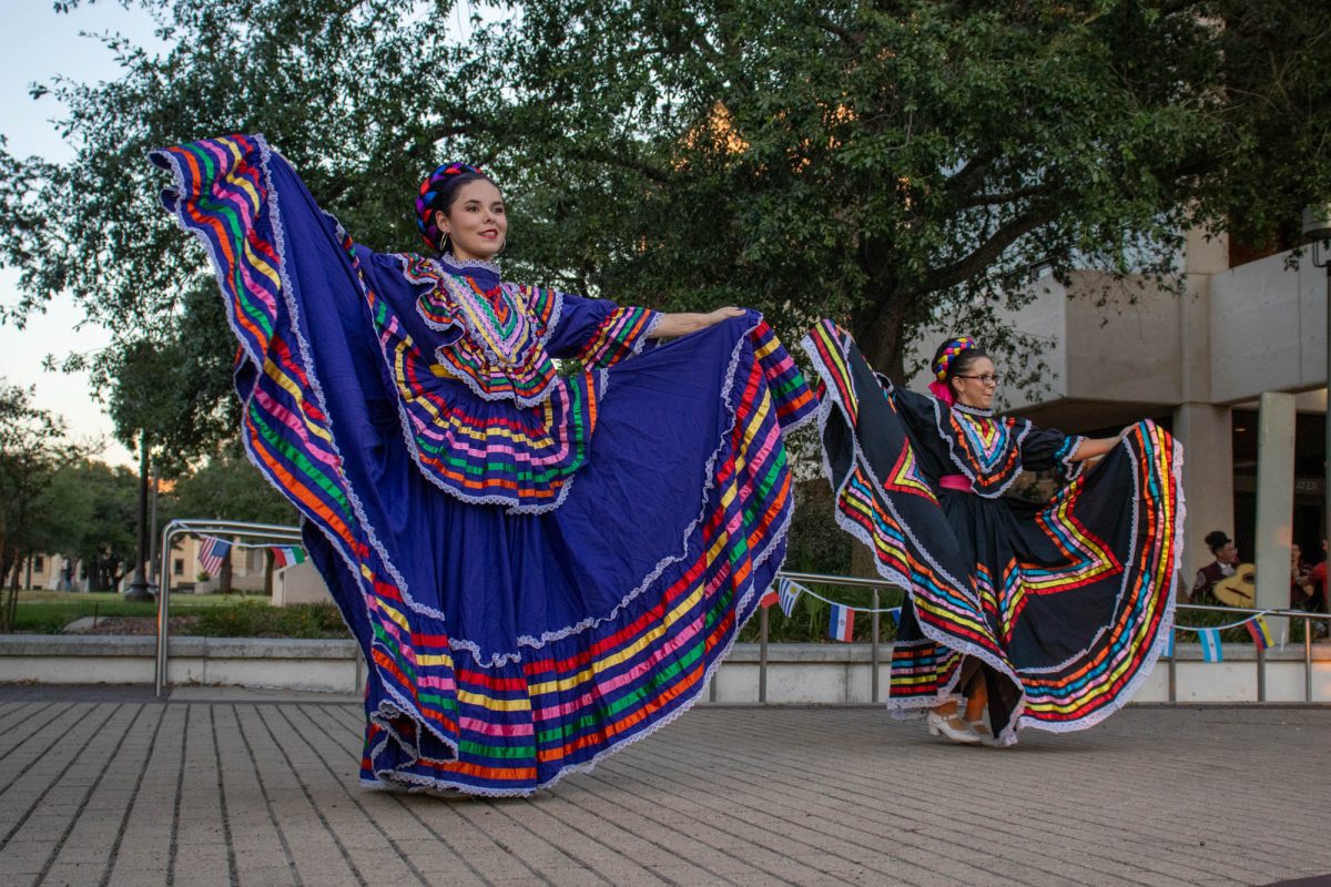 (Left to right) Architecture sophomore Emily Orozco and SEAL senior Elise Hernandez performs for the TAMU Ballet Folkloric Celestial at the HPC Hispanic Heritage Month Kick Off in Rudder Plaza on Monday, Sept. 16, 2024. (Ashely Bautista/The Battalion)