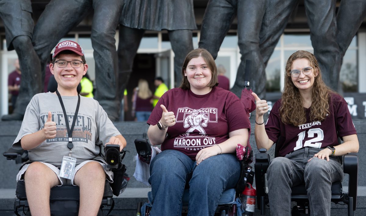 Engineering freshman Benjamin Willis, structural engineering graduate Brianna Vogel and Ashley Lindsey, Class of 2021, pose in front of the Aggie War Hymn Monument before Texas A&M's game against Bowling Green on Saturday, September 21, 2024. (Jenna Isbell/The Battalion)