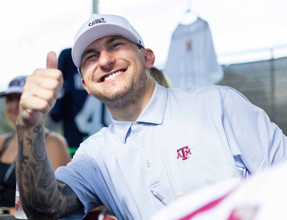 Former Texas A&M quarterback Johnny Manziel poses for a photo at the Legends Only tailgate in Aggie Park on Saturday, Aug 31, 2024 (Adriano Espinosa/The Battalion).