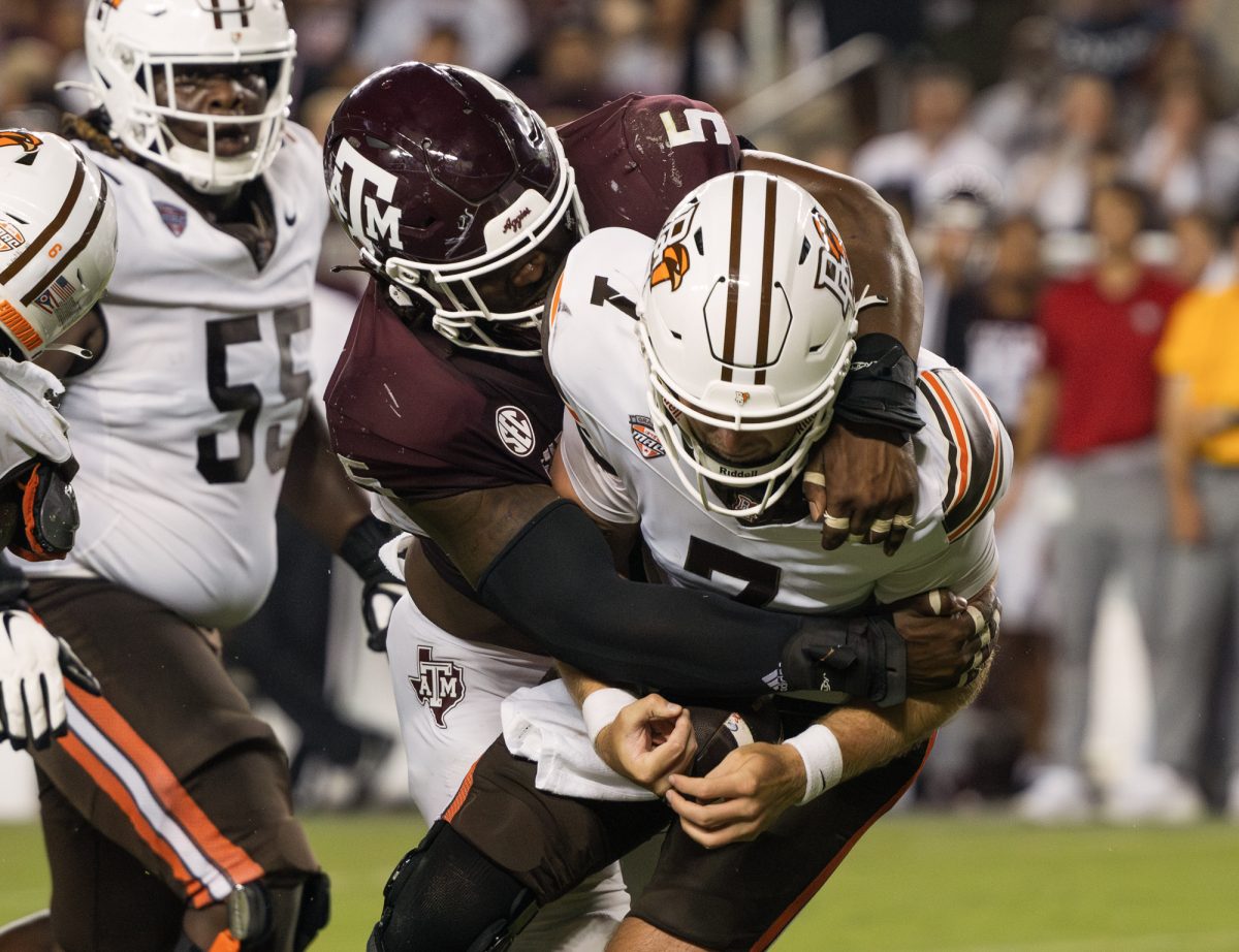 Texas A&M defensive lineman Shemar Turner (5) sacks Bowling Green quarterback Connor Bazelak (7) during Texas A&M's game against Bowling Green on Saturday, September 21, 2024. (Kelii Horvath/The Battalion)