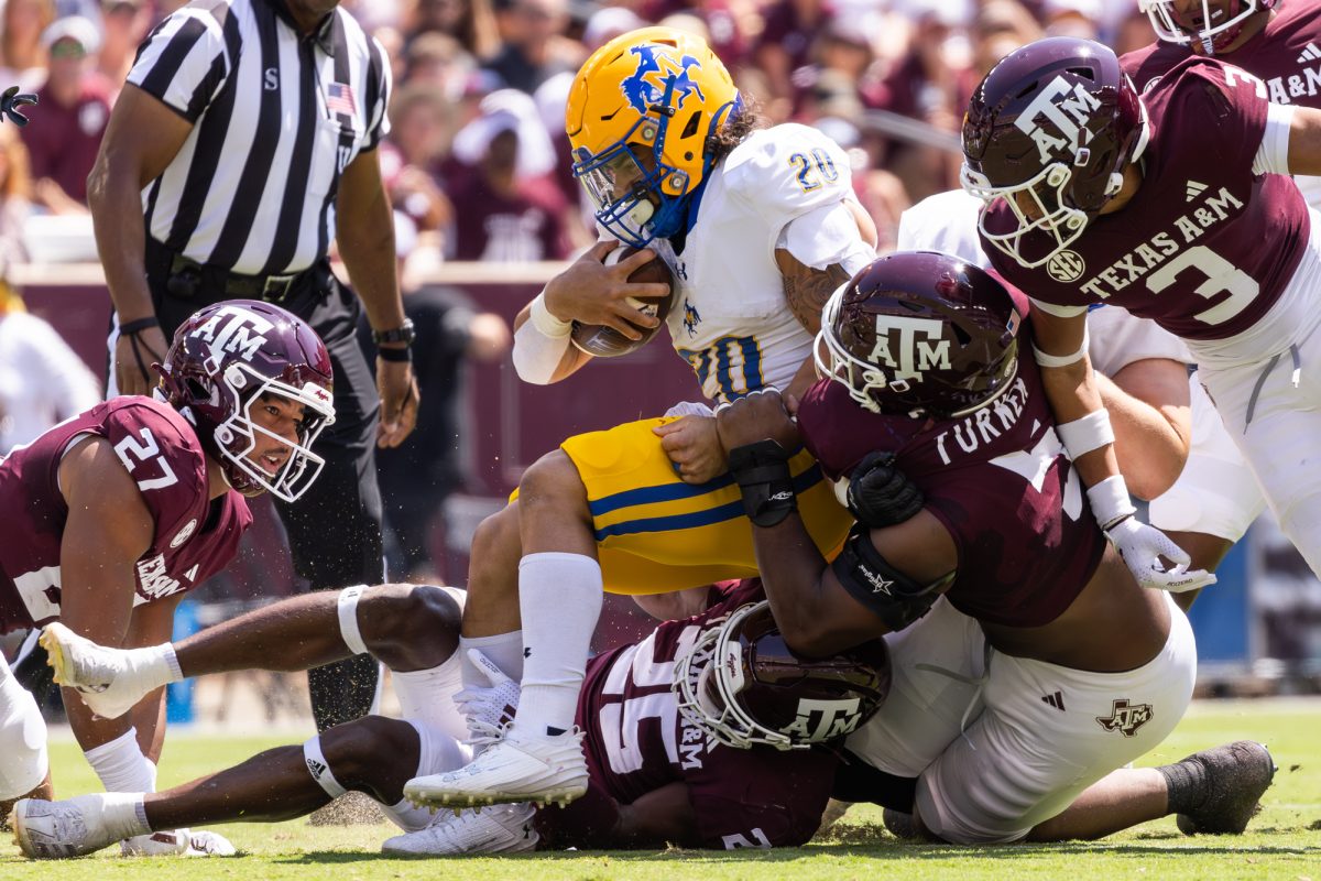 The Texas A&amp;M Aggies' defense takes down McNeese State Cowboys running back Coleby Hamm (20) during Texas A&amp;M’s game against McNeese State at Kyle Field on Saturday, September 7, 2024. (Hannah Harrison/The Battalion)