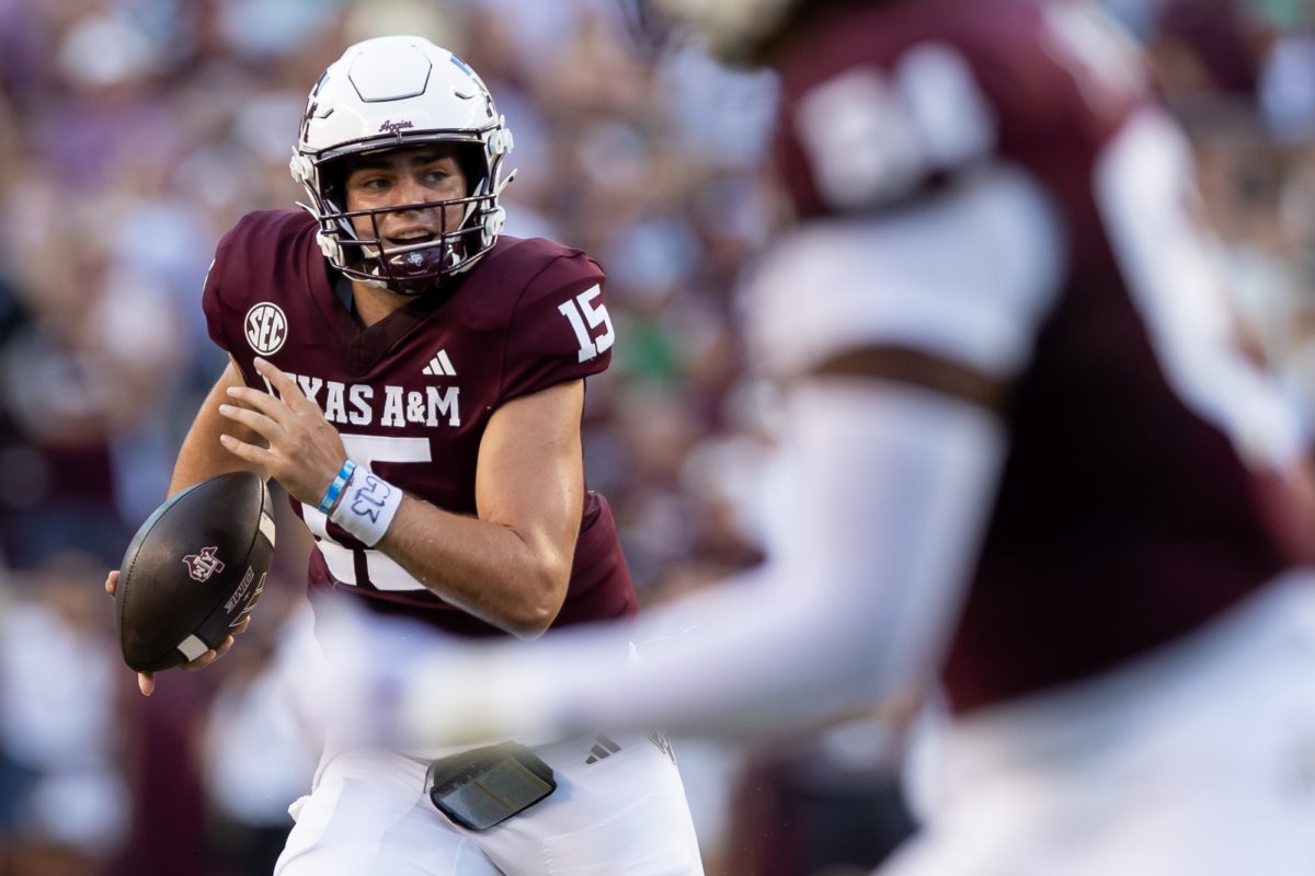 Texas A&amp;M quarterback Conner Weigman (15) scrambles during Texas A&amp;M’s game game against Notre Dame at Kyle Field on Saturday, Aug. 31, 2024. (Chris Swann/The Battalion)