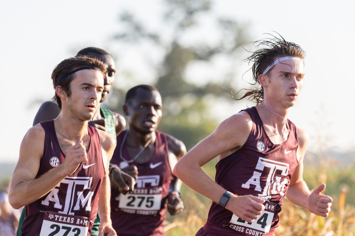 Sophomores Zach Munger, Jack Johnston, and freshman Gilbert Rono box in Tulane freshman Bernard Cheruiyot during Texas A&amp;M's Cross Country Invitational at Dale Watts '71 Cross Country Course on Friday, Sept. 13, 2024. (Adriano Espinosa/The Battalion)