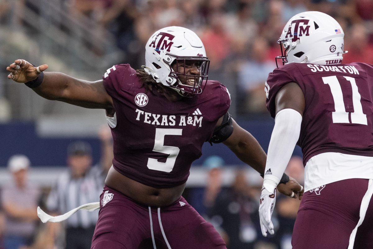 Texas A&amp;M Aggies defensive lineman Shemar Turner (5) and Texas A&amp;M Aggies defensive lineman Nic Scourton (11) react to a play for lost yards during Texas A&amp;M's game against Arkansas at the Southwest Classic at AT&amp;T Stadium in Arlington, Texas on Saturday, Sept. 28, 2024. (Adriano Espinosa/The Battalion)