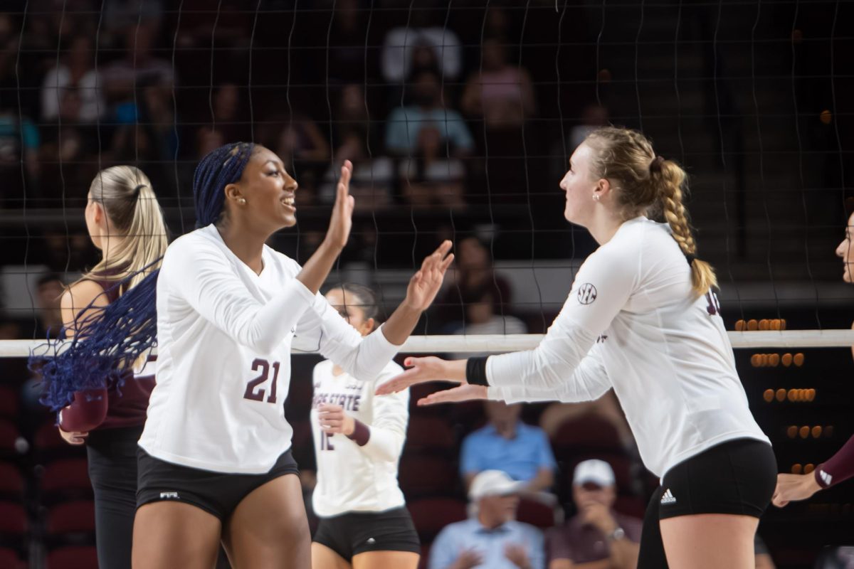 Middle blocker Morgan Perkins (21) high fives setter Maddie Waak (16) during Texas A&M's game against Texas State at Reed Arena on Friday, Sept. 6, 2024. (Jaime Rowe/The Battalion)