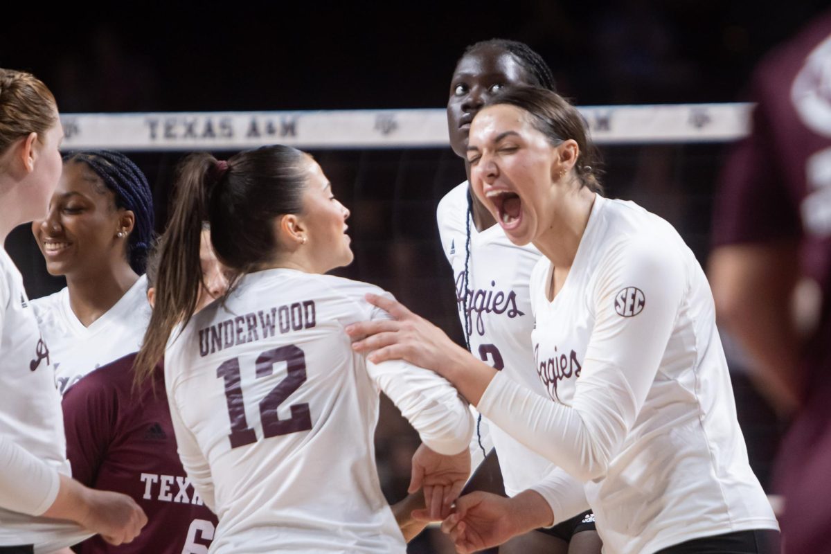 Opposite Logan Lednicky (9) celebrates with defense specialist Ava Underwood (12) during Texas A&M's game against Texas State at Reed Arena on Friday, Sept. 6, 2024. (Jaime Rowe/The Battalion)