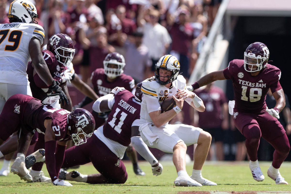 Missouri Tigers quarterback Brady Cook (12) gets sacked by multiple Aggies during Texas A&amp;M’s game against Missouri at Kyle Field Saturday, Oct. 5, 2024. (Kelii Horvath/The Battalion)