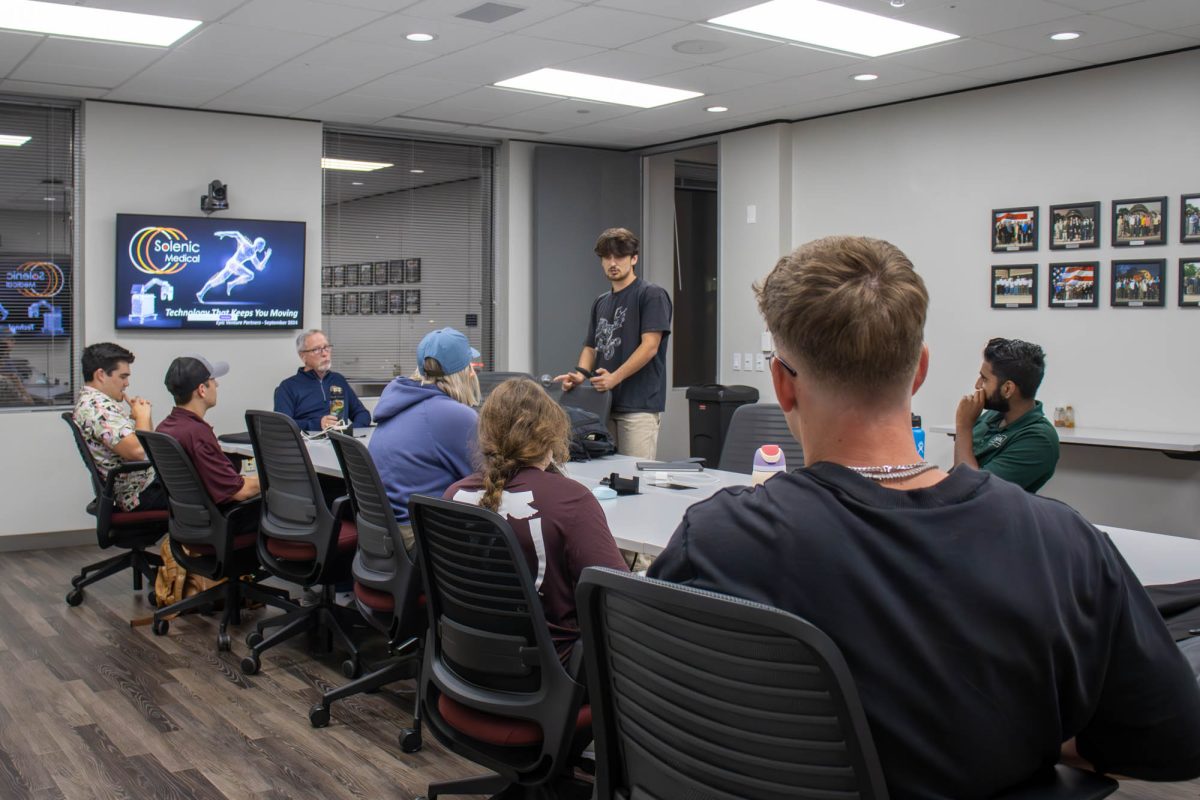 Students listening to society, ethics, and law senior Christopher Mascardo's announcement for being finalized for TAMU's Collegiate Entrepreneurs Organization at the Aggie Entrepreneurs workshop in the McFerrin Center for Entrepreneurship Conference Room Thursday, Oct. 24, 2024. (Ashely Bautista/The Battalion)