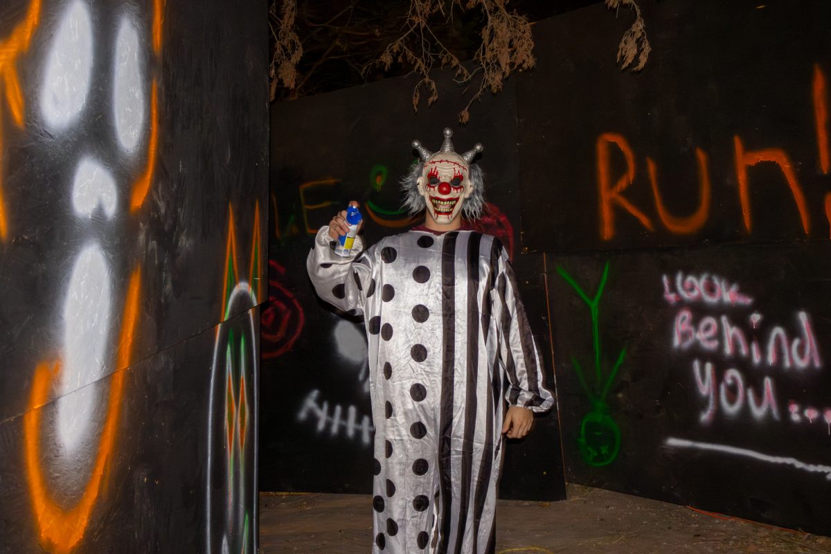 A clown slowly approaches participants In Kappa Sigma's Wicked Woods on Friday, Oct. 25, 2024.