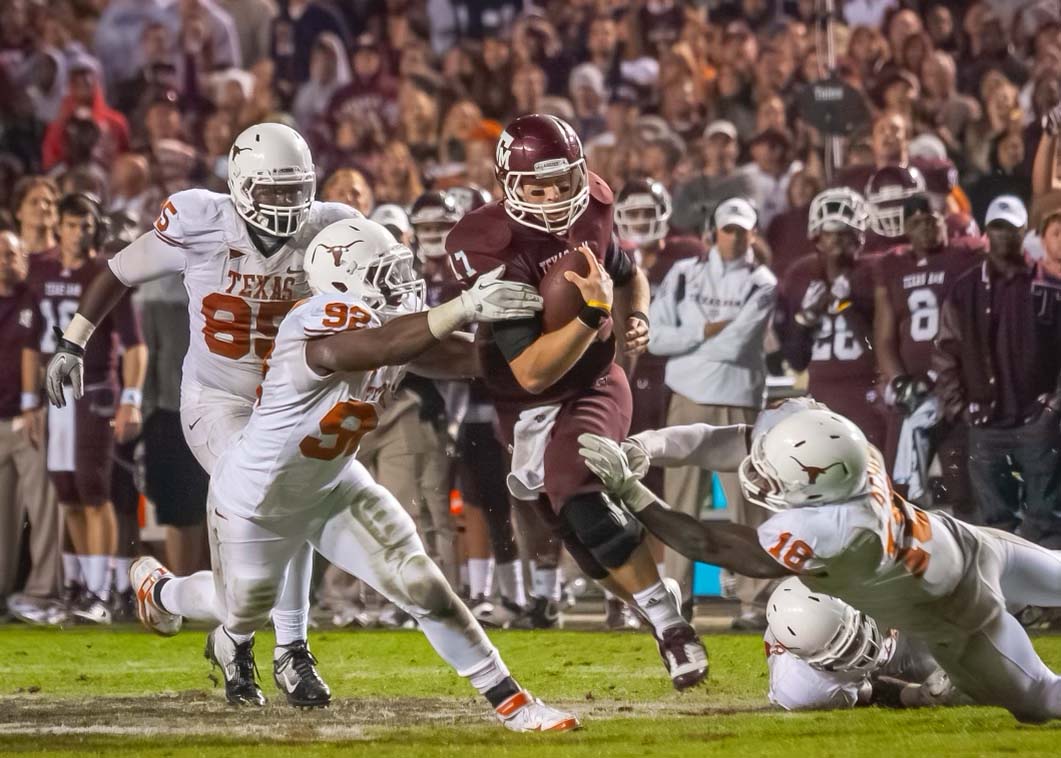 Texas A&amp;M quarterback Ryan Tannehill (17) carries the ball past Texas defenders during Texas A&amp;M’s game against Texas at Kyle Field on November 24, 2011. (FILE)