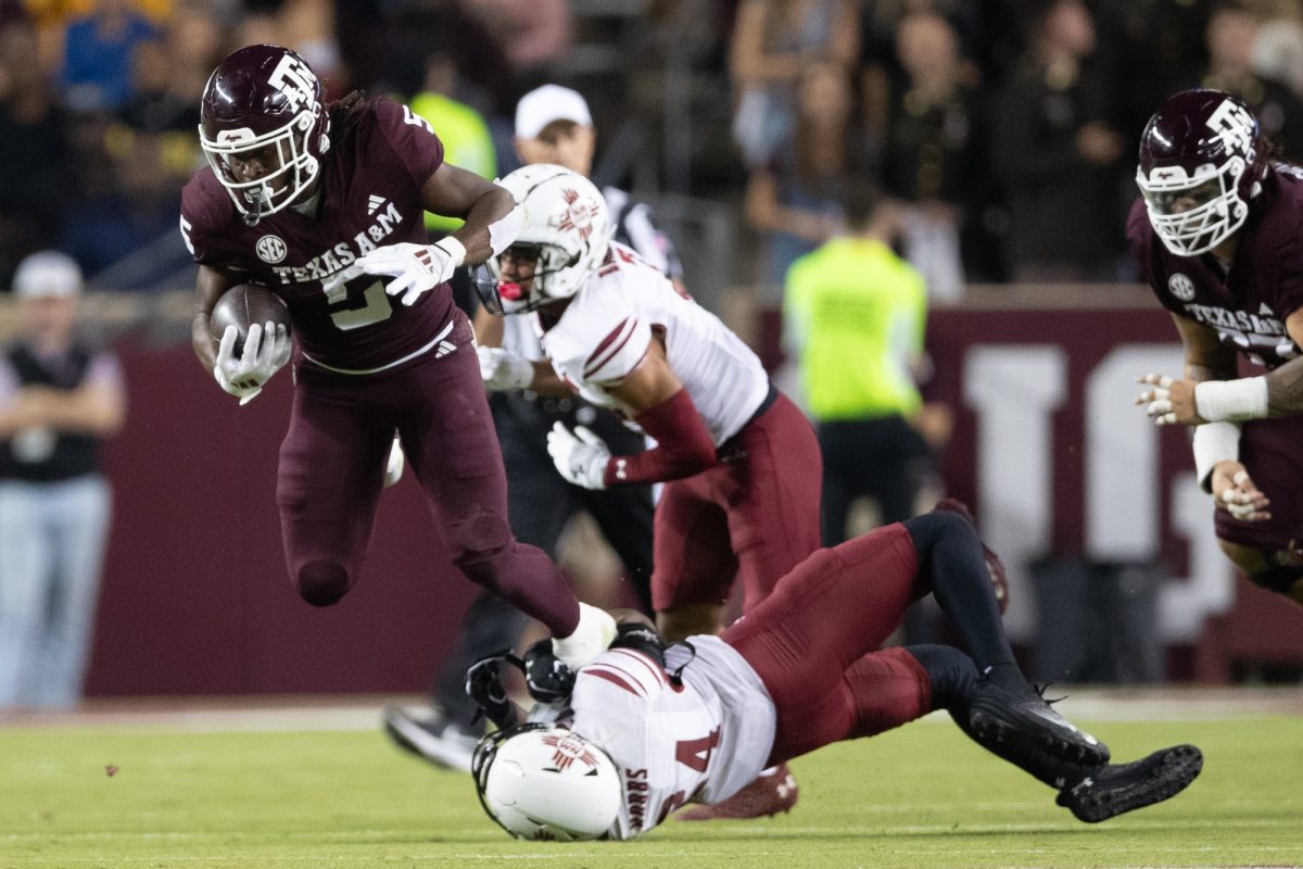 Texas A&M running back Amari Daniels (5) breaks a tackle as he makes a 71-yard touchdown run during Texas A&M’s game against New Mexico State at Kyle Field on Saturday, Nov. 16, 2024. (Chris Swann/The Battalion)