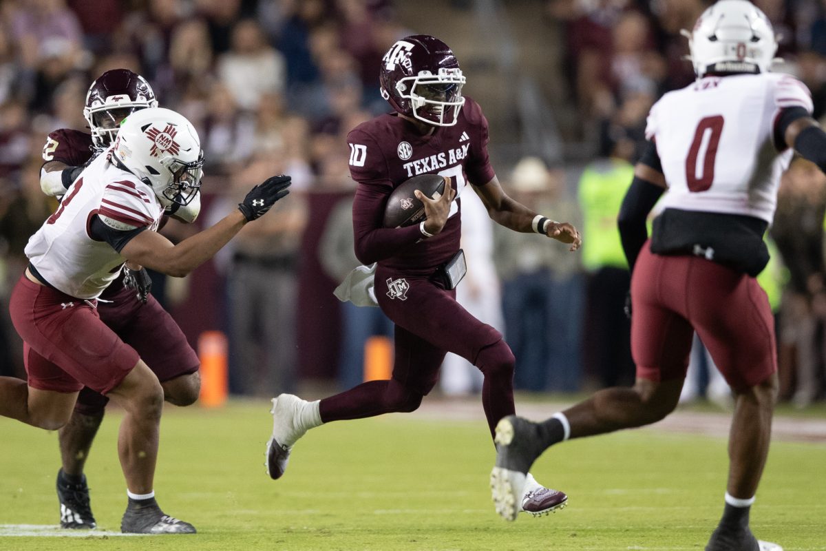 Texas A&amp;M quarterback Marcel Reed (10) rushes past New Mexico State defenders during Texas A&amp;M’s game against New Mexico State at Kyle Field on Saturday, Nov. 16, 2024. (Chris Swann/The Battalion)