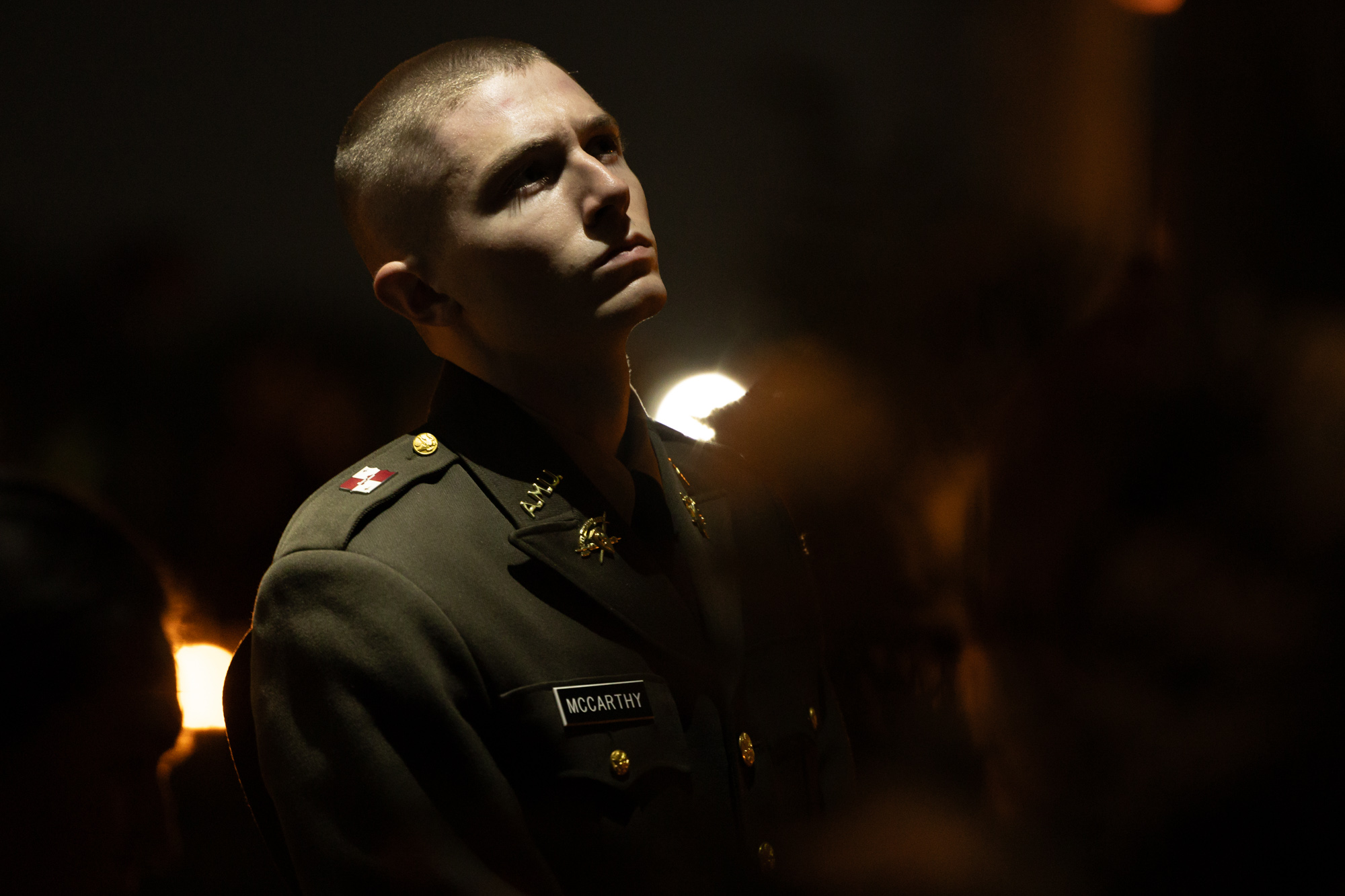 A member of the Corps of Cadets reads the written reflection within one of the 12 portals during the Bonfire Remembrance Ceremony at the Bonfire Memorial on Monday, Nov. 18, 2024. 