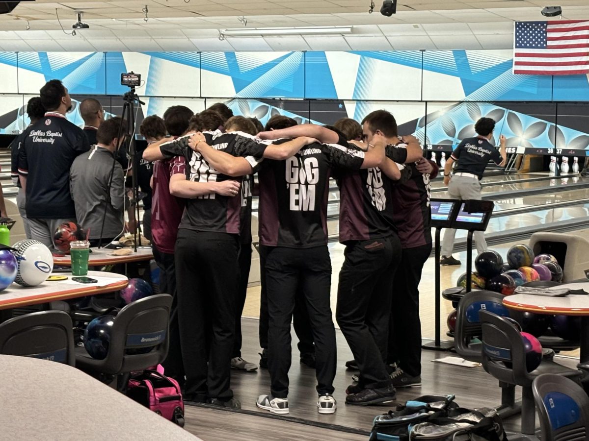 The Texas A&M men's bowling club huddles before Game 1 of the Southwest Intercollegiate Bowling Conference in Fort Worth on Nov. 9, 2024.