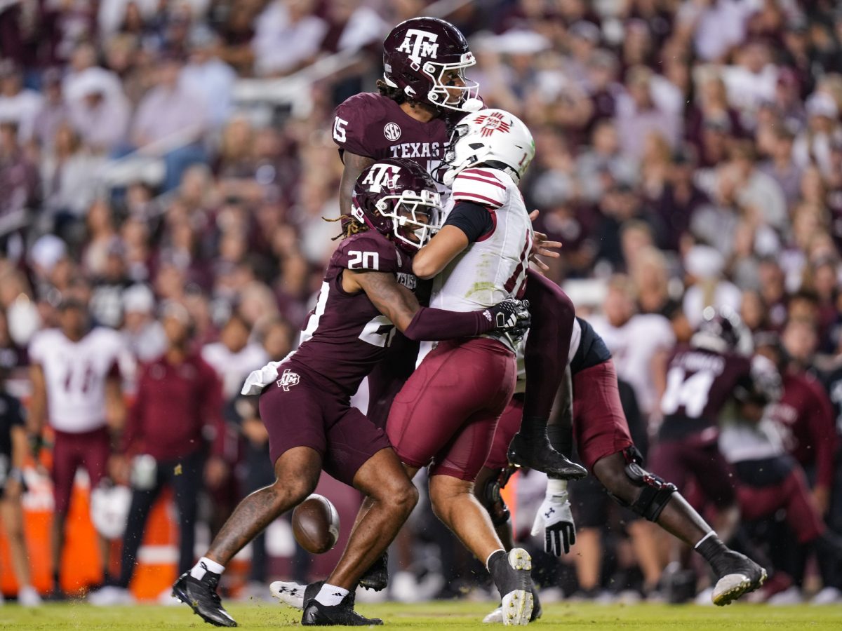 Texas A&amp;M defensive back BJ Mayes (20) and Texas A&amp;M defensive lineman Rylan Kennedy (15) sack New Mexico State quarterback Santino Marucci (18) during Texas A&amp;M’s game against New Mexico State at Kyle Field on Saturday, Nov. 16, 2024. (Hannah Harrison/The Battalion)