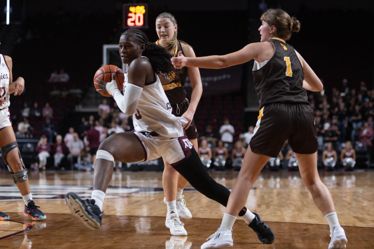 Texas A&M guard Aicha Coulibaly (5) strides past defenders during Texas A&M’s game against Western Michigan at Reed Arena on Sunday, Nov. 10, 2024. (Trinity Hindman/The Battalion)