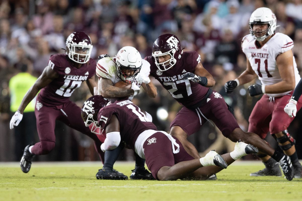 Texas A&amp;M defensive lineman Nic Scourton (11) tackles New Mexico State running back Seth McGowan (1) during Texas A&amp;M’s game against New Mexico State at Kyle Field on Saturday, Nov. 16, 2024. (Trinity Hindman/The Battalion)