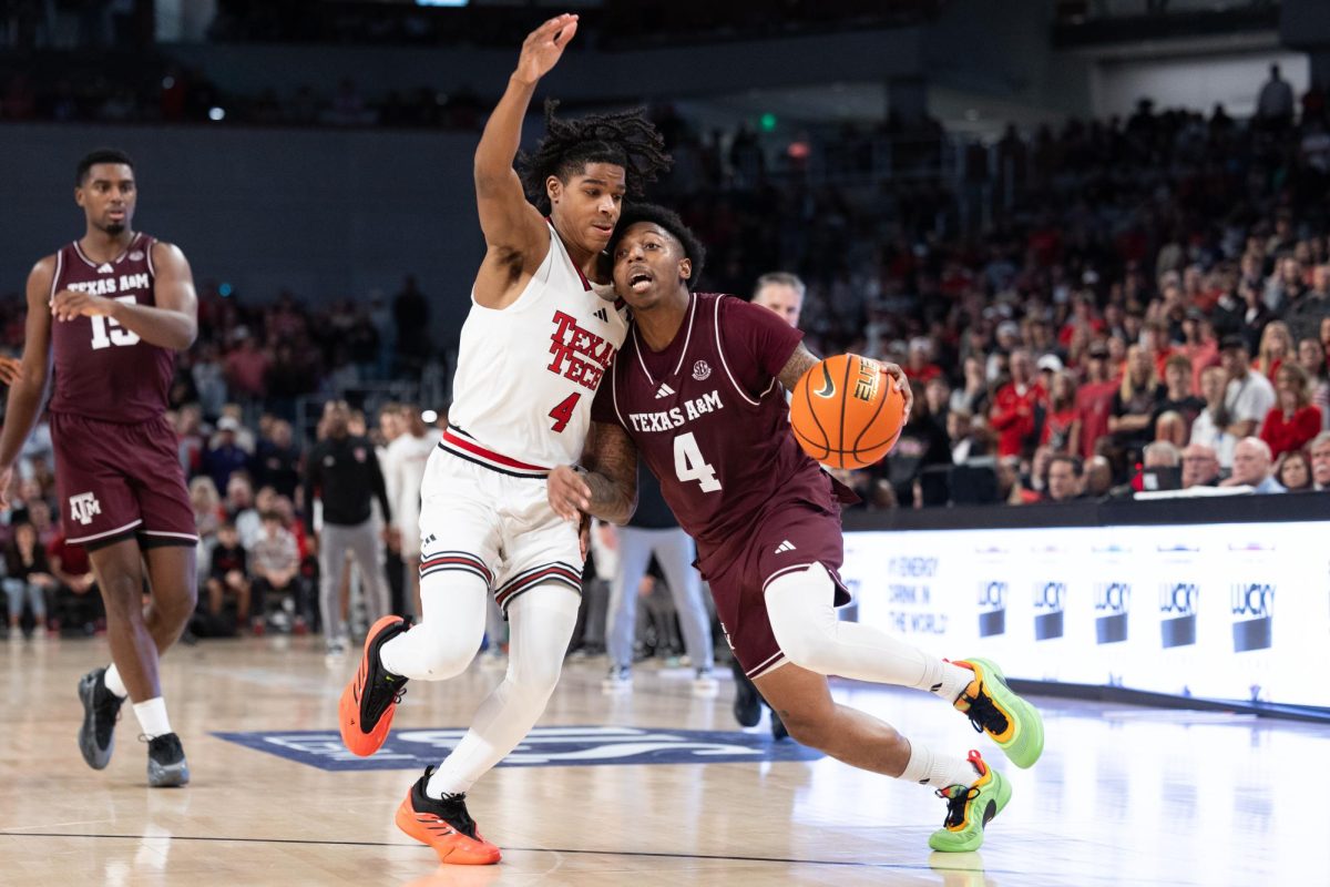 Texas A&M guard Wade Taylor IV (4) drives past Texas Tech guard Christian Anderson (4)  during Texas A&M’s game against Texas Tech at Dickies Arena in Fort Worth, Texas on Sunday, Dec. 8, 2024. (Chris Swann/The Battalion)