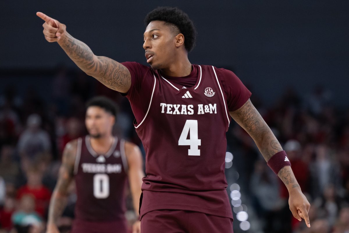 Texas A&amp;M guard Wade Taylor IV (4) points during Texas A&amp;M’s game against Texas Tech at Dickies Arena in Fort Worth, Texas on Sunday, Dec. 8, 2024. (Chris Swann/The Battalion)