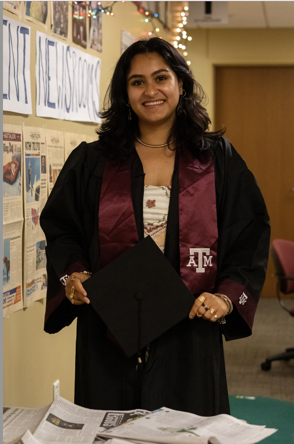 Features Writer Shalina Sabih poses in the Battalion newsroom in her graduation gown.