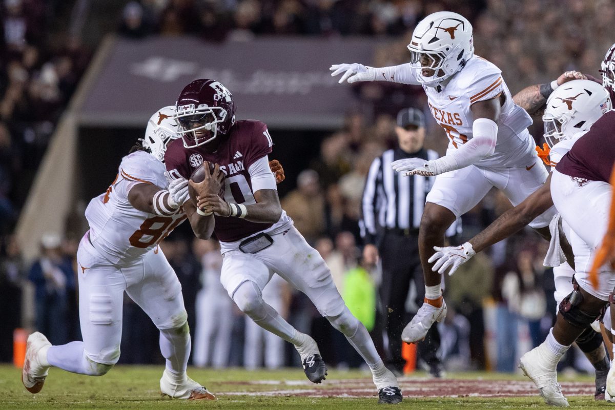 Texas A&amp;M quarterback Marcel Reed (10) faces defensive pressure during Texas A&amp;M's game against Texas at Kyle Field on Saturday, Nov. 30, 2024. (Adriano Espinosa/The Battalion)