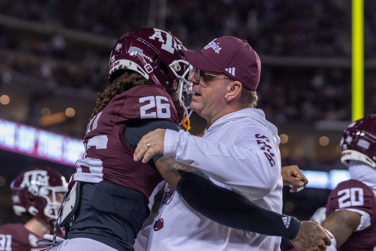 Texas A&amp;M head coach Mike Elko and Texas A&amp;M defensive back Will Lee III (26) embrace before Texas A&amp;M's game against Texas at Kyle Field on Saturday, Nov. 30, 2024. (Adriano Espinosa/The Battalion)