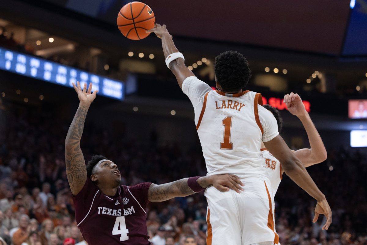 Texas guard Julian Larry (1) blocks a shot from Texas A&M guard Wade Taylor IV (4) to give The Longhorns the ball with less than 20 seconds left during the second half of Texas A&M’s game against Texas at The Moody Center in Austin, Texas on Saturday, Jan. 25, 2024. (Chris Swann/The Battalion)