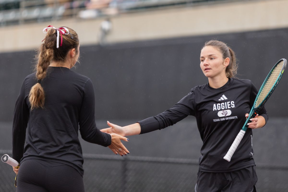 Junior Jeanette Mireles and Junior Nicole Khirin high-five during Texas A&M's match against TCU at Mitchell Tennis Center on Saturday, Jan. 18, 2025. (Adriano Espinosa/The Battalion)