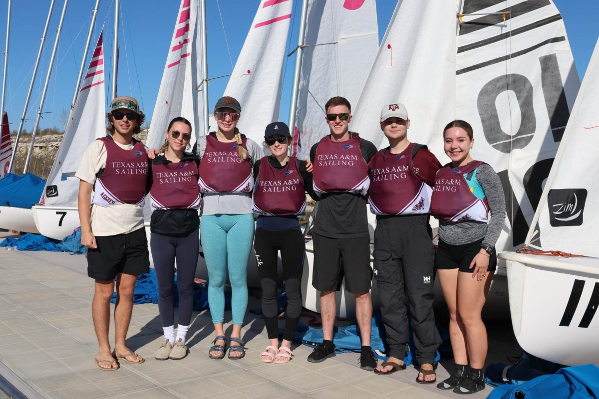 Texas A&M Sailing Team members pose in front of Club 420 sailboats at the Q1 Regatta in Austin on Sunday, Feb. 2, 2025. Photo credit: Cole Broberg