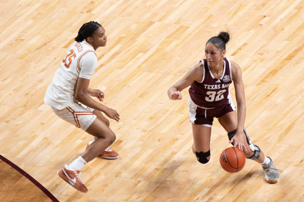 Texas A&M forward Lauren Ware (32) drives past defenders during Texas A&M’s game against Texas at Reed Arena on Sunday, Feb. 2, 2025. (Trinity Hindman/The Battalion)