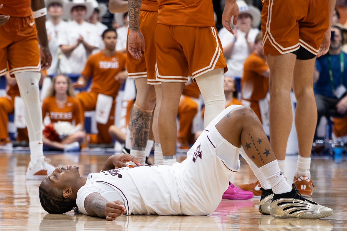 Texas A&M guard Wade Taylor IV (4) lays on the ground after fighting for a ball during Texas A&M’s game against Texas at the SEC Tournament held in Bridgestone Arena in Nashville, Tennessee, on Thursday, March 13, 2025. (Hannah Harrison/The Battalion)