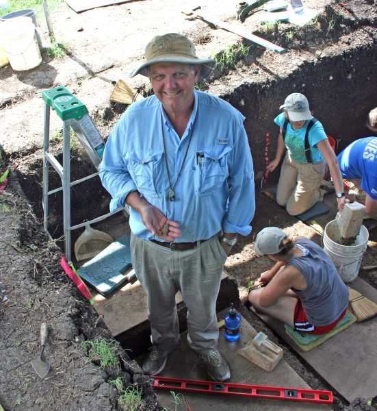 1a. Michael Waters holding 15,000 year old projectile point in excavation area on the day it was discovered. Friedkin Site, Texas